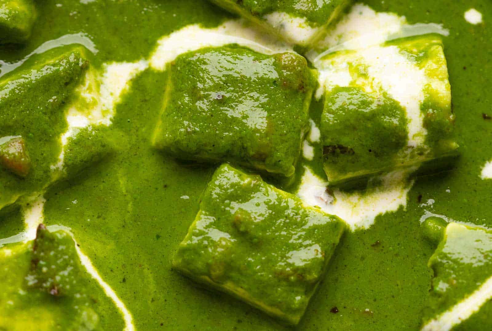Closeup of the palak paneer gravy to show the luxurious, rich curry base