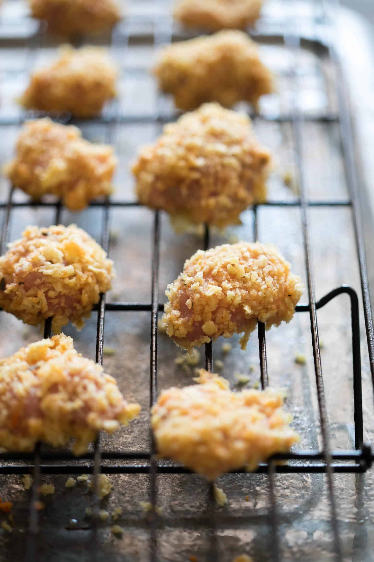 The easiest recipe for baked popcorn chicken that can be made two ways - spicy and non spicy! Tastes KFC style, but gluten free and guilt free for the perfect party appetizer. 