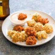 Baked popcorn chicken made 2 ways and served with sriracha mayo.