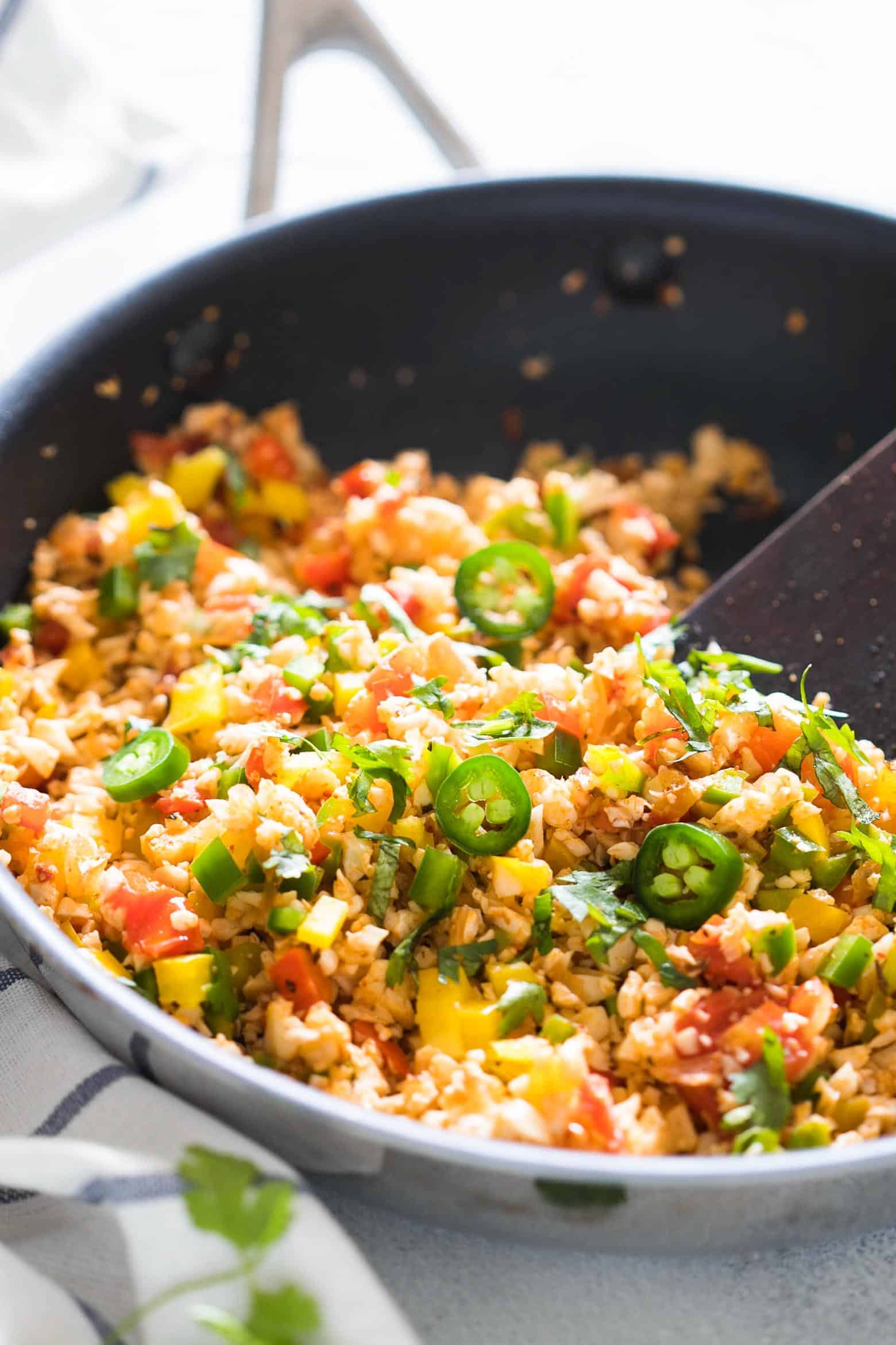Low Carb Mexican Cauliflower Rice is a healthy, paleo friendly, keto friendly, vegan side dish recipe that is bursting with mexican flavours and ready in 30 minutes!