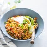 Low Carb Mexican Cauliflower Rice topped with sour cream and avocados.