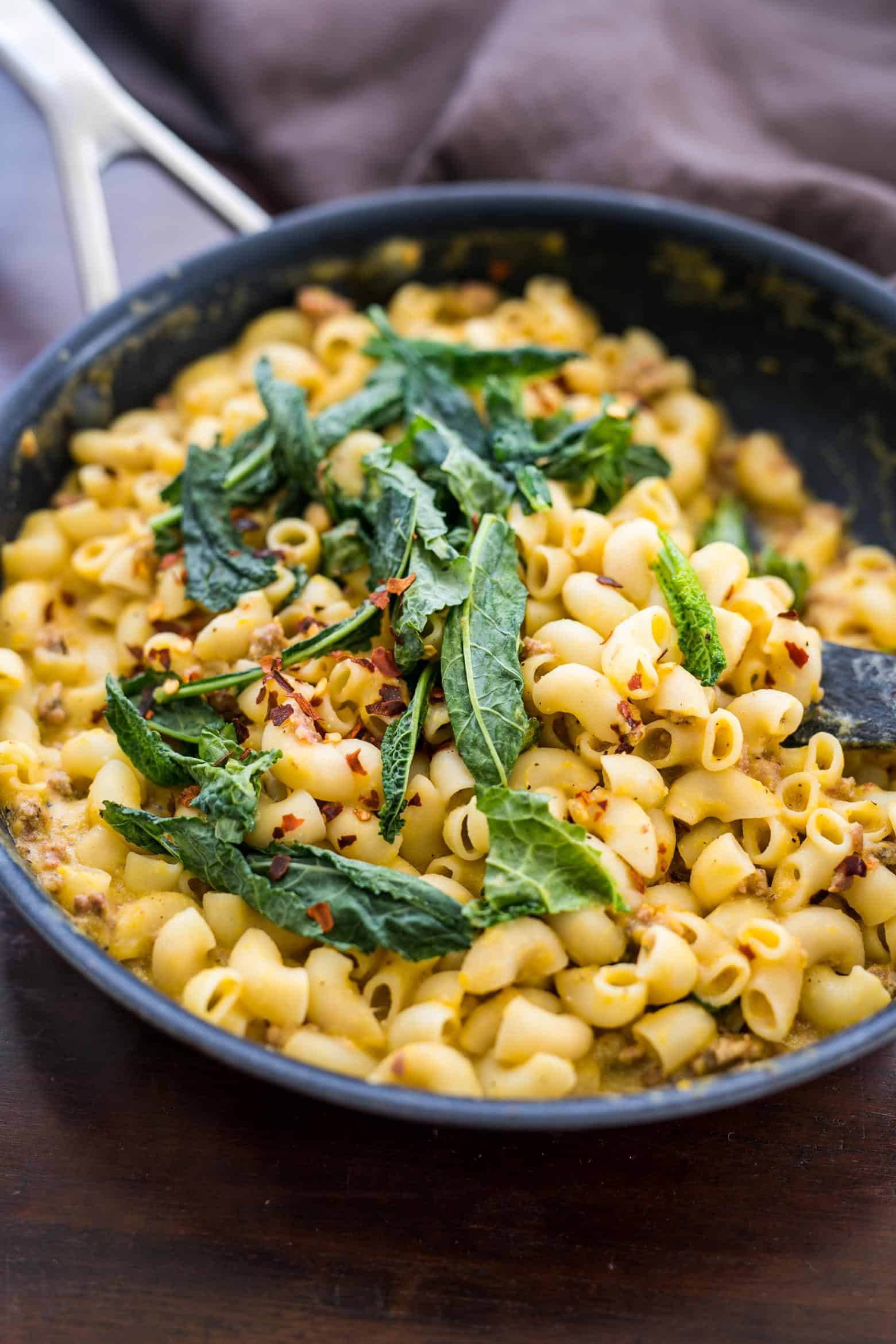 Creamy pumpkin sausage mac and cheese with kale is pure comfort food! It's a fast, easy dinner recipe when you crave homemade pasta in a bowl.