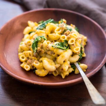Creamy pumpkin sausage mac and cheese with kale is pure comfort food! It's a fast, easy dinner recipe when you crave homemade pasta.