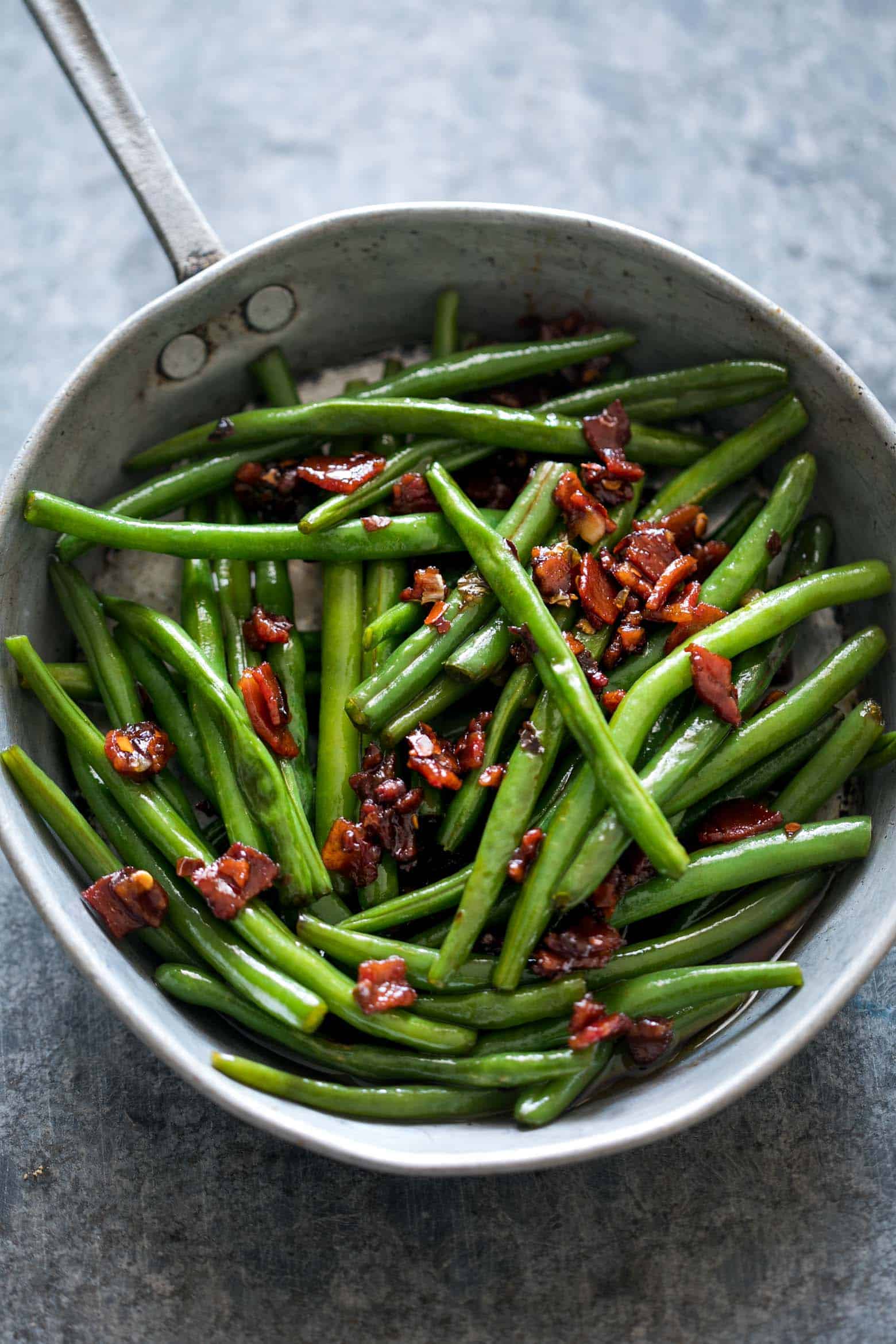 Sauteed Brown Sugar Bacon Garlic Green Beans is an insanely delicious side dish - sweet, garlicky with bits of candied bacon. Everyone will ask for seconds!