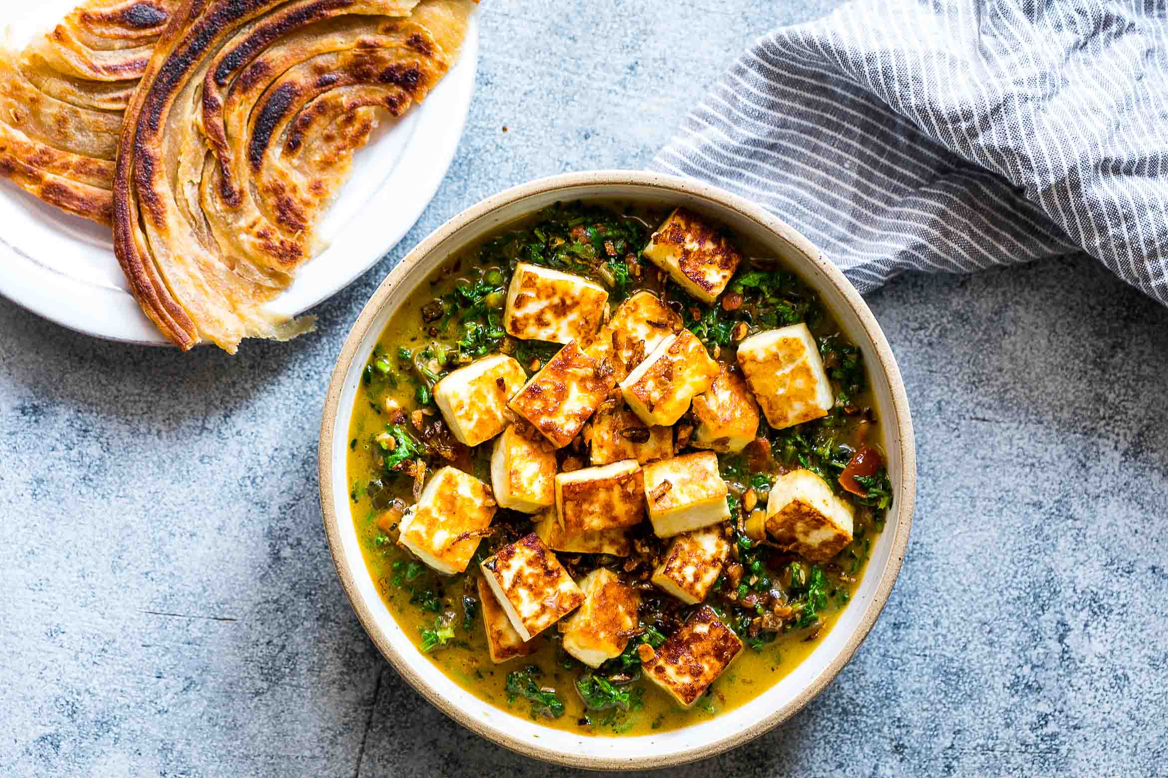 This healthy saag paneer is an easy, Indian recipe thats full of flavour and uses mustard greens or arugula and spinach. Gluten free & ready in 30 minutes.