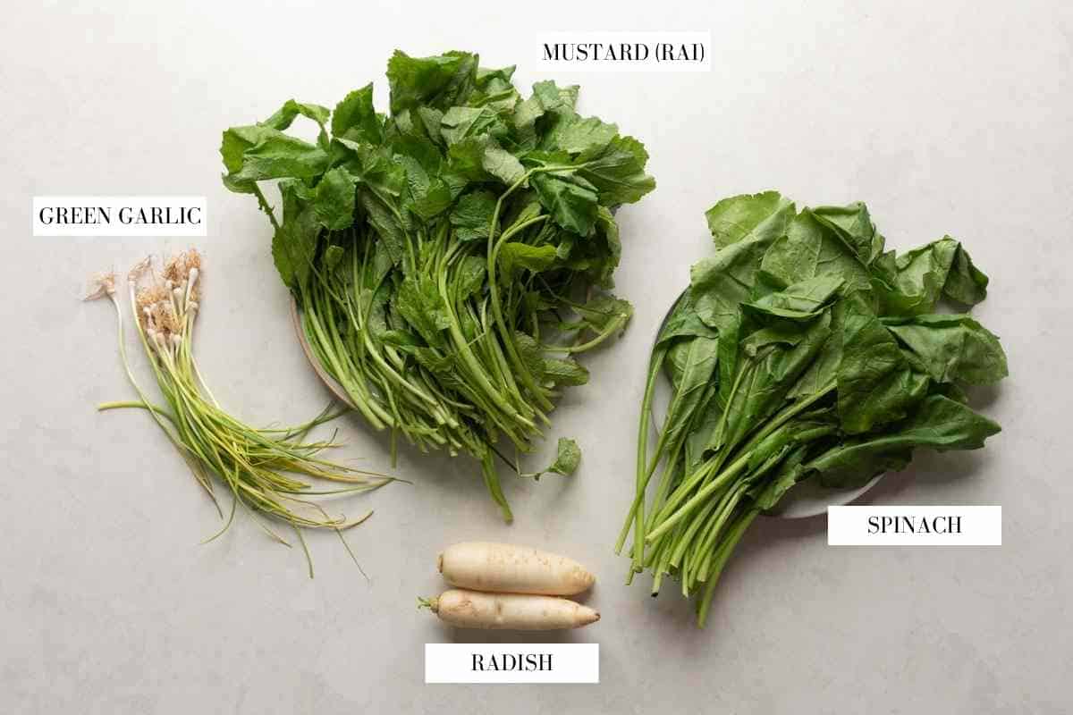 Picture of all the greens going into saag paneer with text to identify them