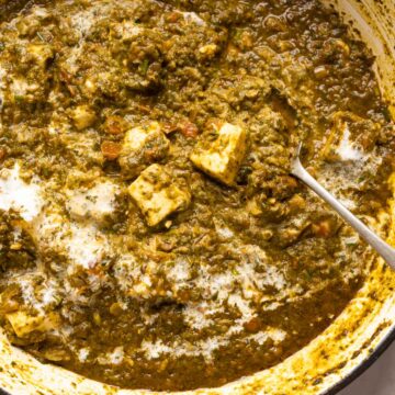 Picture of saag paneer in the pan that it was cooked in with a spoon