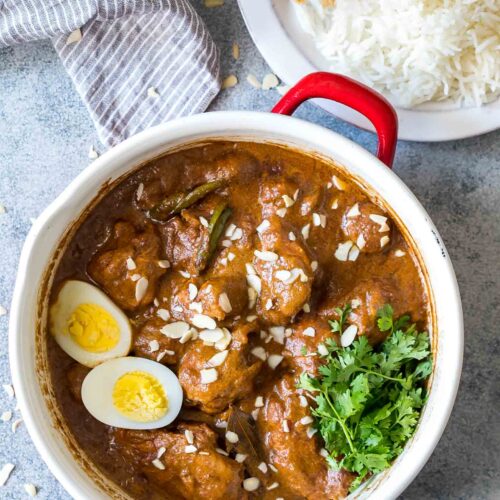 Mughlai Chicken garnished with coriander and boiled eggs.