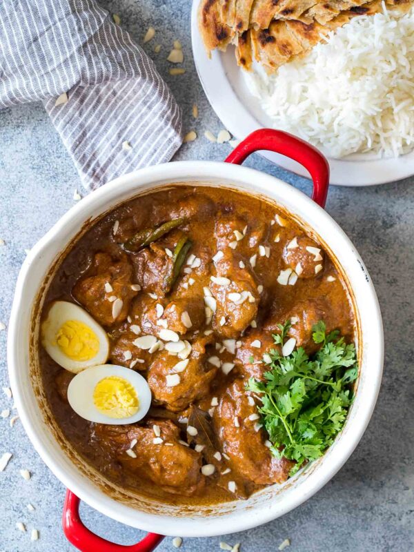 Mughlai Chicken garnished with coriander and boiled eggs.