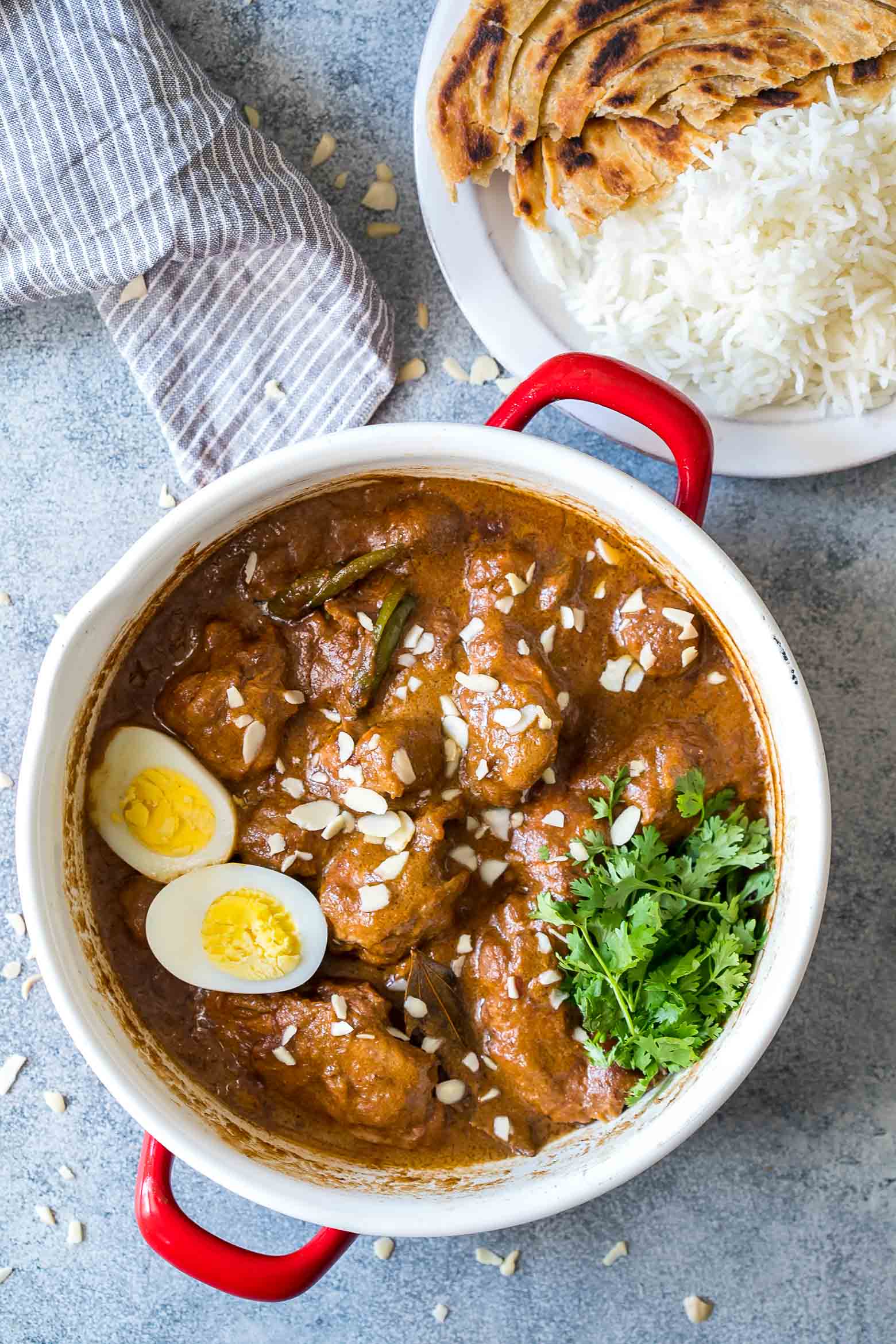 Mughlai Chicken is a restaurant style, north Indian recipe with a creamy, dark brown onion gravy that will have you licking the plate! Serve it with parathas, biryani or jeera rice, and feel free to substitute paneer if you are vegetarian.