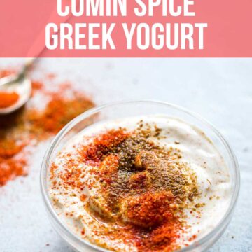 Cumin spice greek yogurt served in a bowl with cumin and chilli powder sprinkled on top