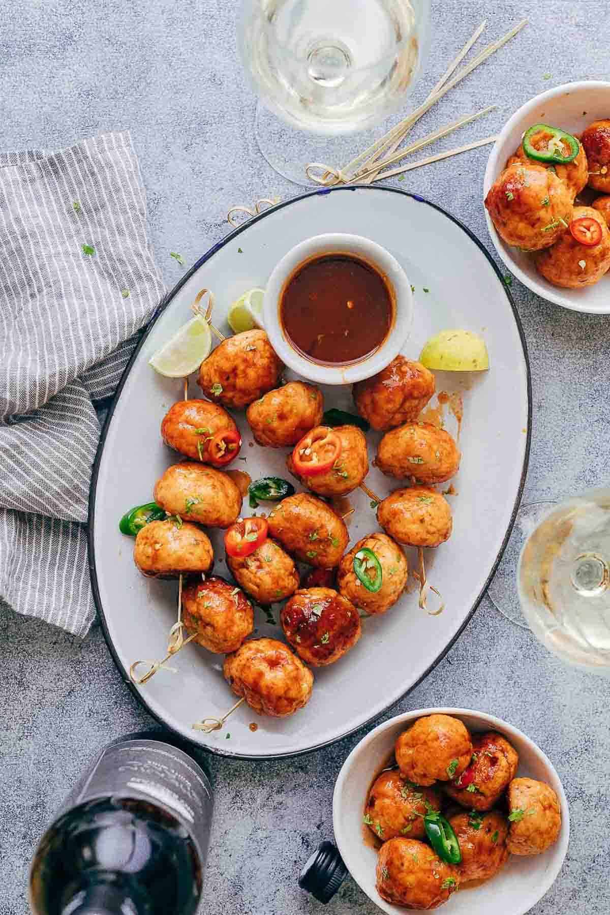 Baked firecracker chicken meatballs are juicy, spicy and saucy! This easy appetizer is perfect for holiday parties. Each meatball is super tender and full of flavour.