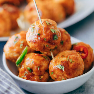 Baked firecracker chicken meatballs are juicy, spicy and saucy! This easy appetizer is perfect for holiday parties. Each meatball is super tender and full of flavour.