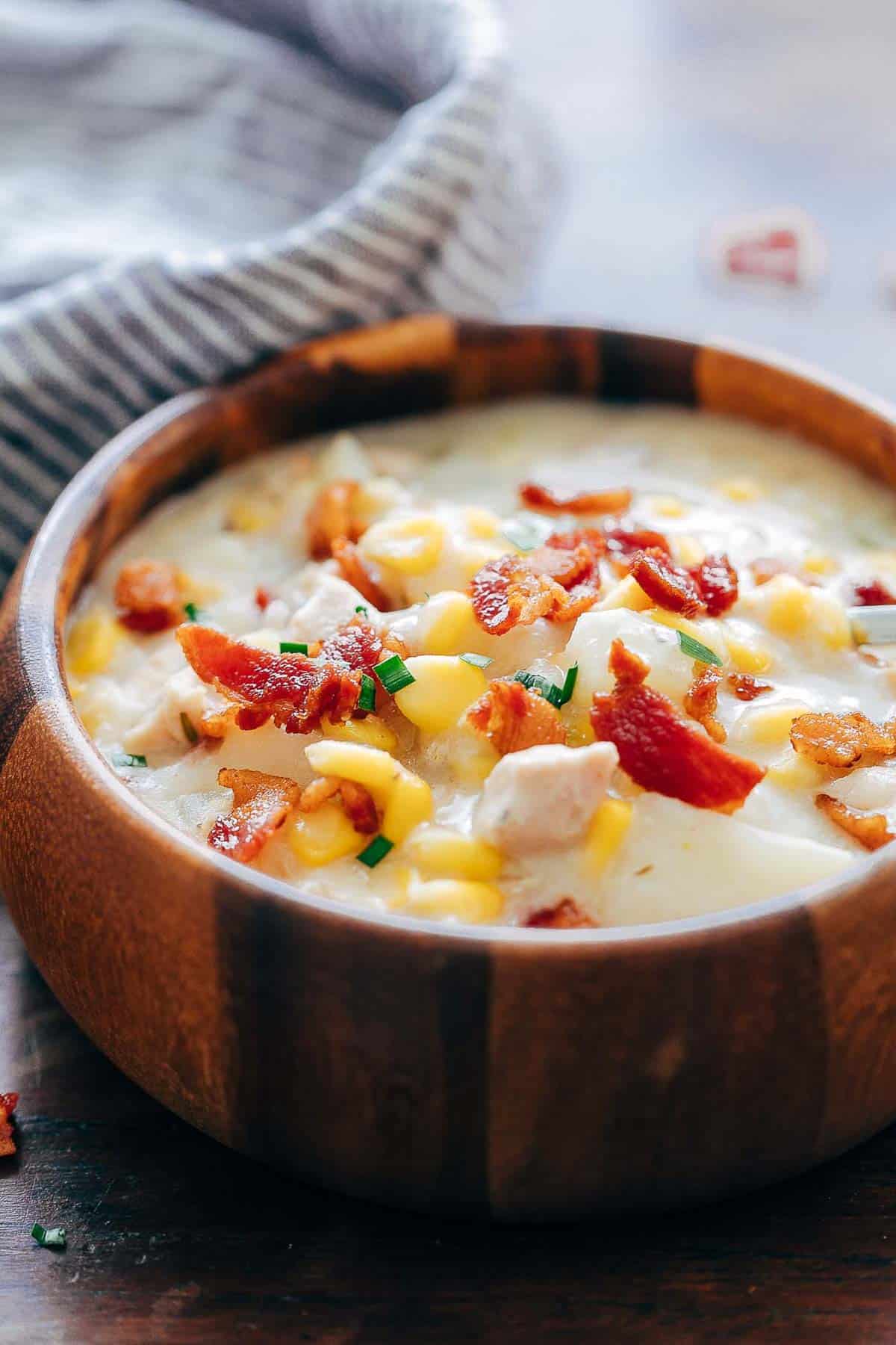 Instant Pot Chicken Potato Corn Chowder with Bacon served in a wooden bowl.