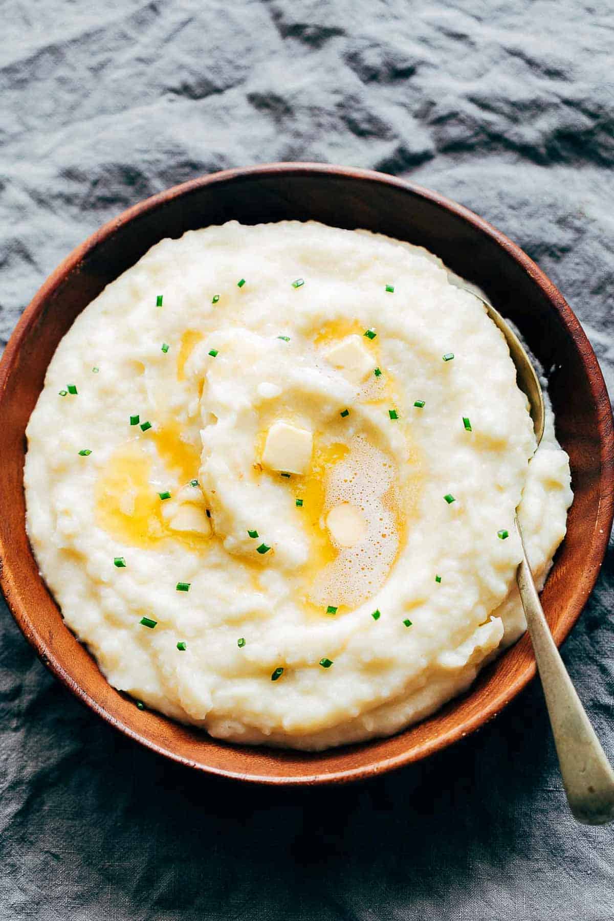 Mashed potatoes flavored with garlic and served in a wooden bowl.