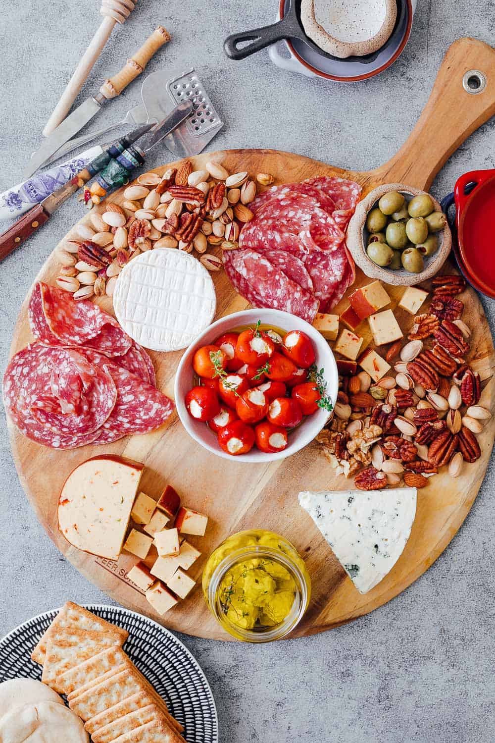 Step #4 is to add salty nibbles such as olives, stuffed peppers, labneh etc to the ultimate wine and cheese board. Pick things that are already in your pantry so that you don't spend on anything additional
