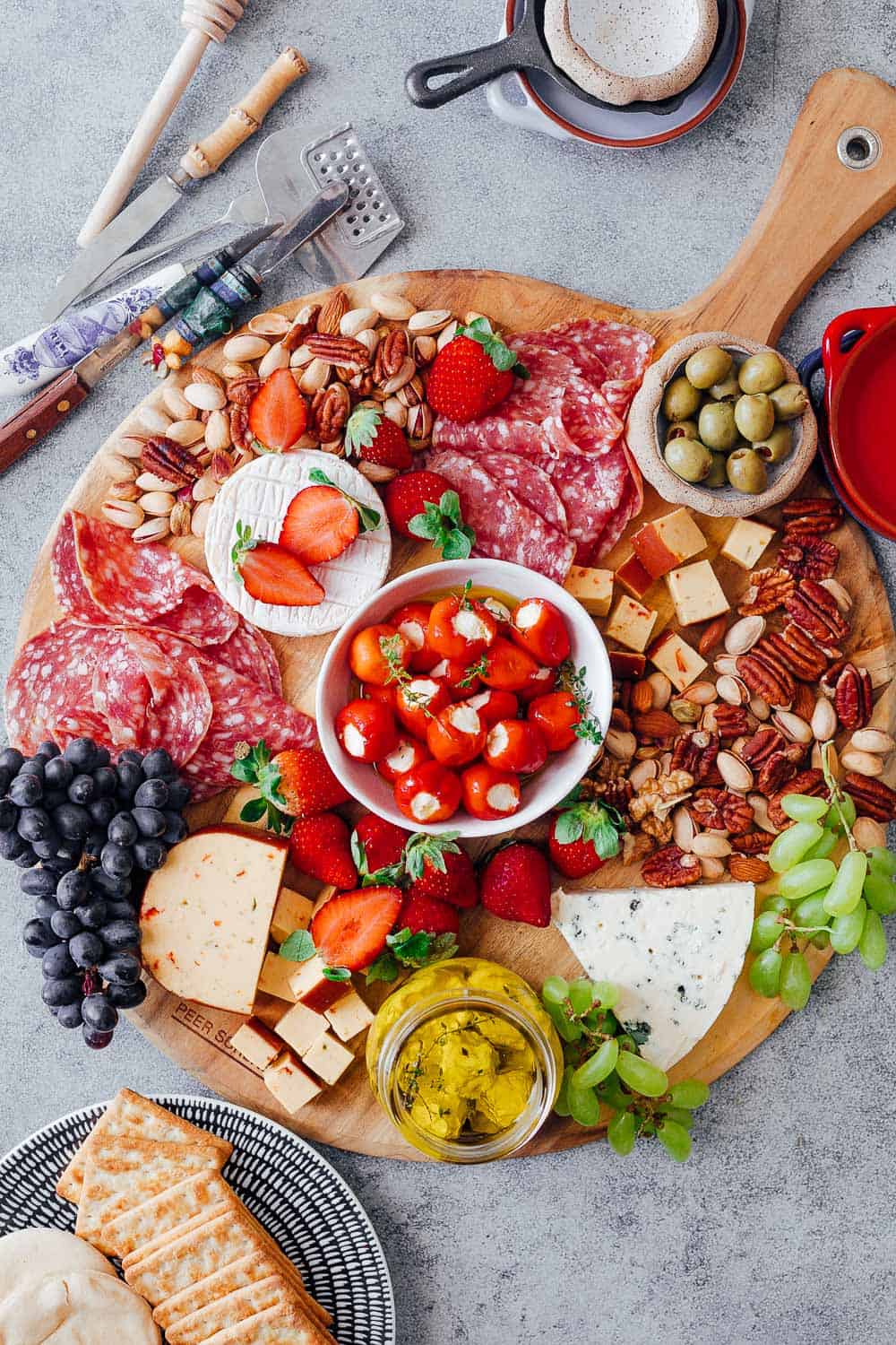 Step #5 in creating the ultimate wine and cheese board is to add local, seasonal fruits to the board. This helps keep the cost down as seasonal fruits are usually the cheapest