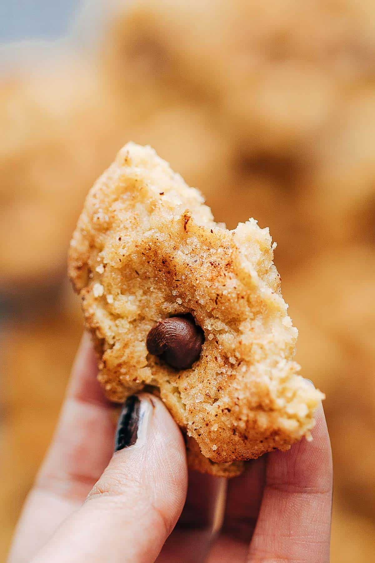 A bite of pumpkin snickerdoodle cookies to show how soft and chewy they are without cream of tartar
