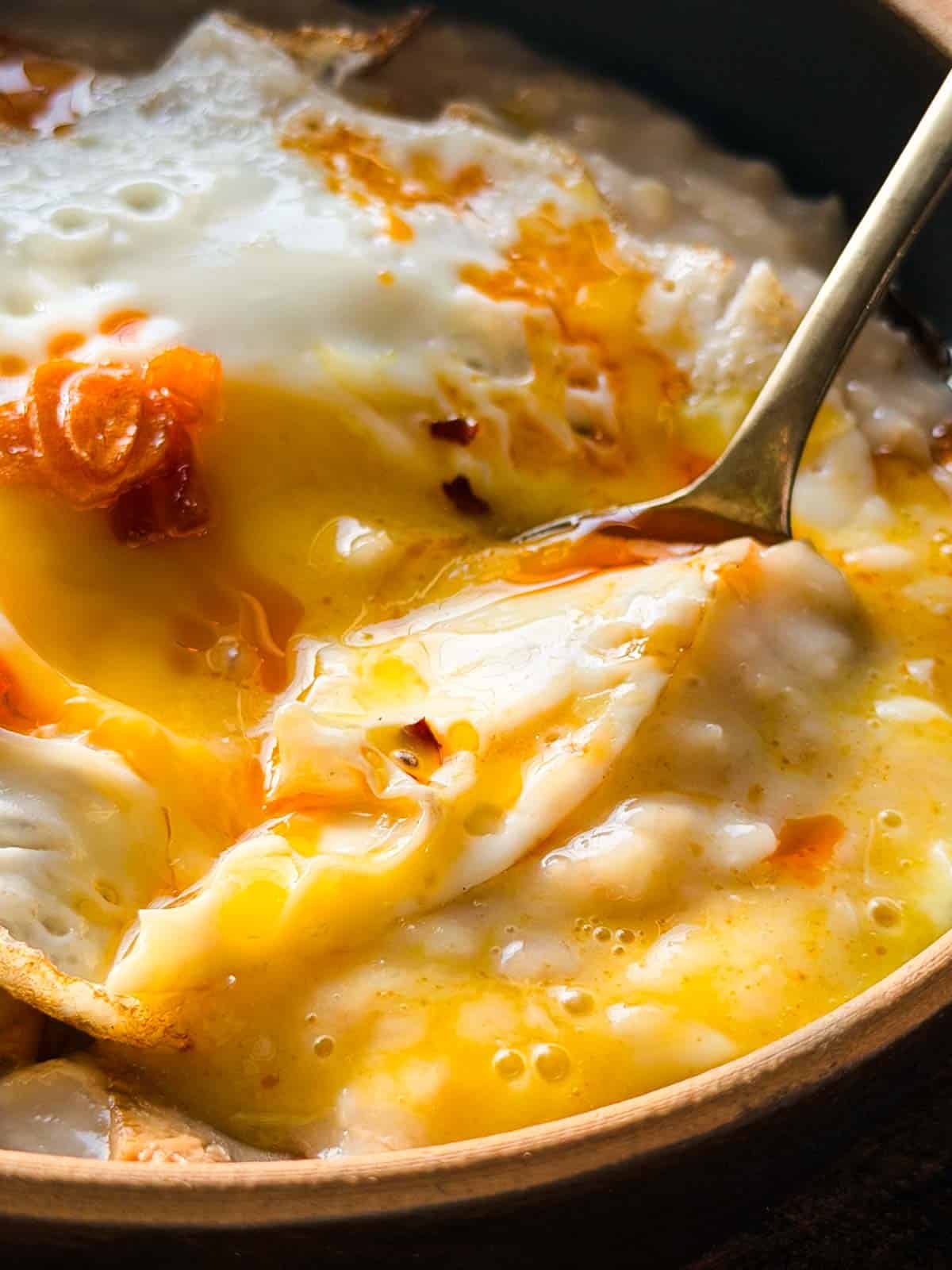 a close up image of savoury garlic oats to showcase it's creamy texture