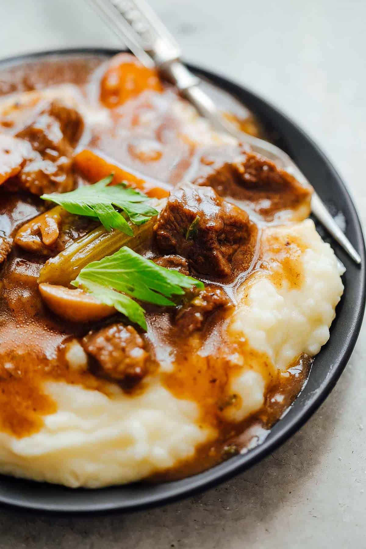 Easy Instant Pot Beef Stew served with mashed potatoes.