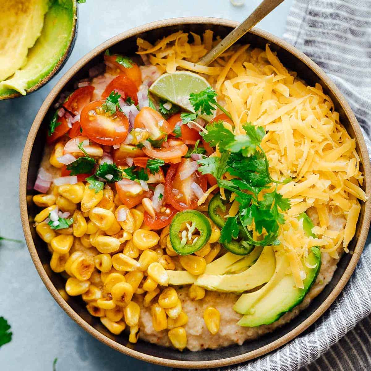 This Mexican oatmeal bowl is the healthier version of a Mexican breakfast bowl. The oatmeal is seasoned with all the spices that go into your favorite taco, and then topped with salsa, corn, avocado, jalapenos and cheddar. Super simple to make but you’ll feel like a king when you dig into this!
