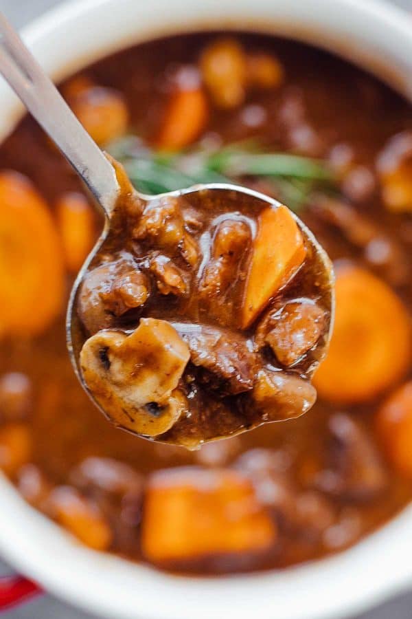 Pressure Cooker Beef Bourguignon ladled out on a spoon