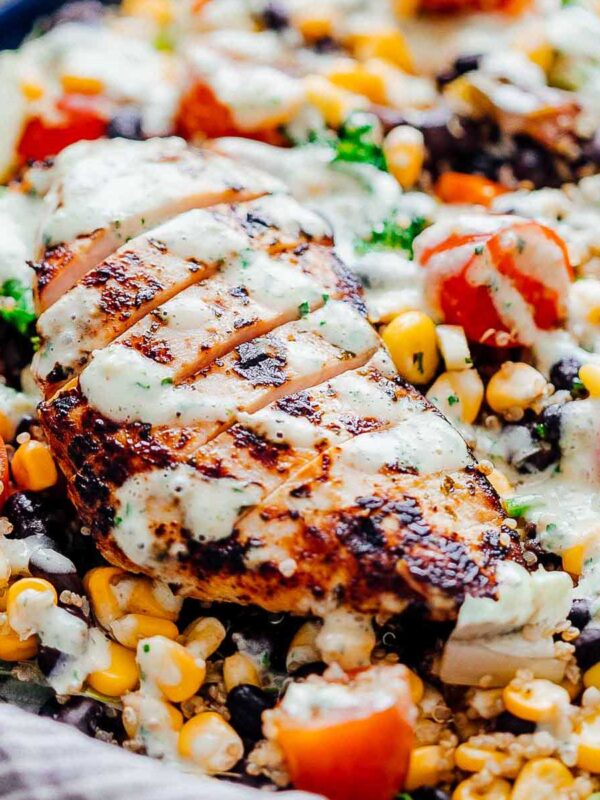 Closeup of dressing drizzled on southwest chicken quinoa bean salad
