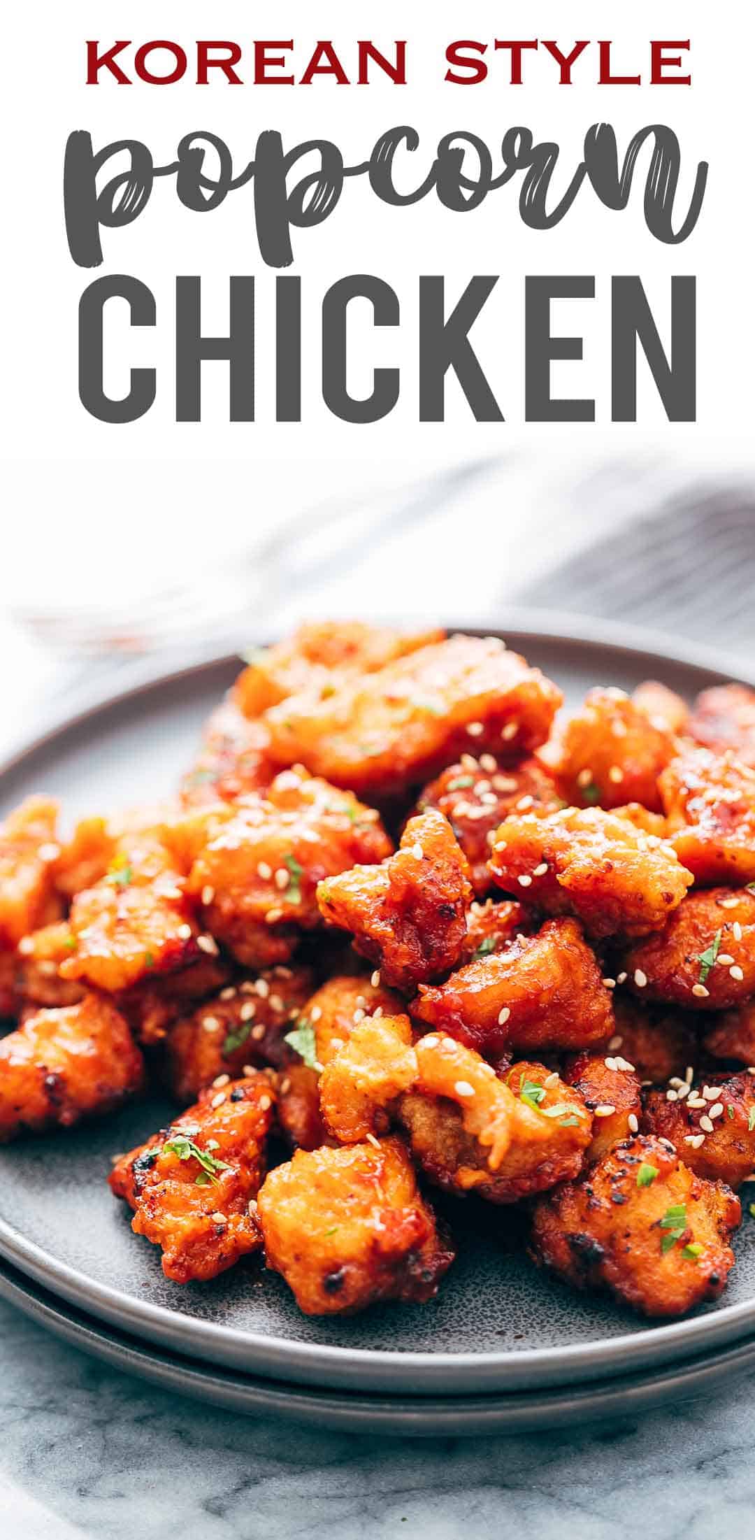 KOREAN POPCORN CHICKEN is sticky, spicy, tangy and crunchy. Inspired by the hyper-famous Korean street snack, Dakgangjeong, boneless chicken is deep fried and tossed in a sweet, sour and spicy sauce that makes every bite super addictive. #chicken #appetizer #party #snack #recipe