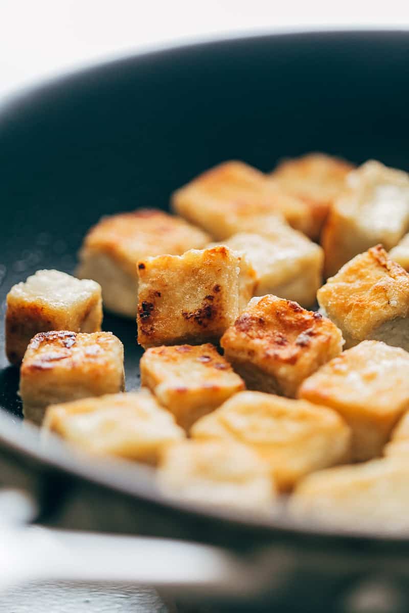 Crispy tofu panfried in a non stick pan till golden brown on all sides