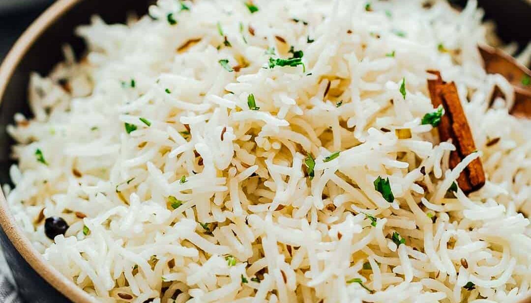 Close up of the perfect, steamed jeera rice or Indian cumin rice served in a bowl