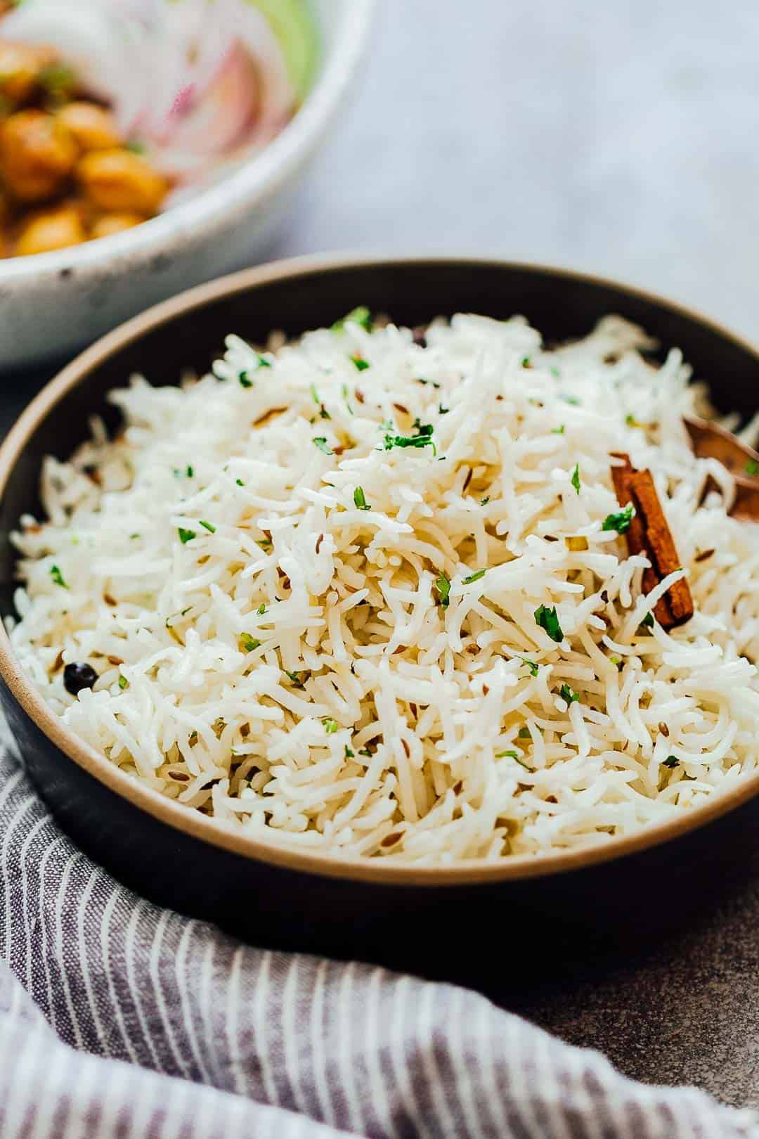 Close up of the perfect, steamed jeera rice or Indian cumin rice served in a bowl
