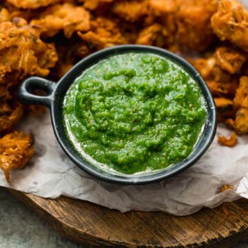 Green Cilanatro Chutney served with pakoras or fritters on the side.