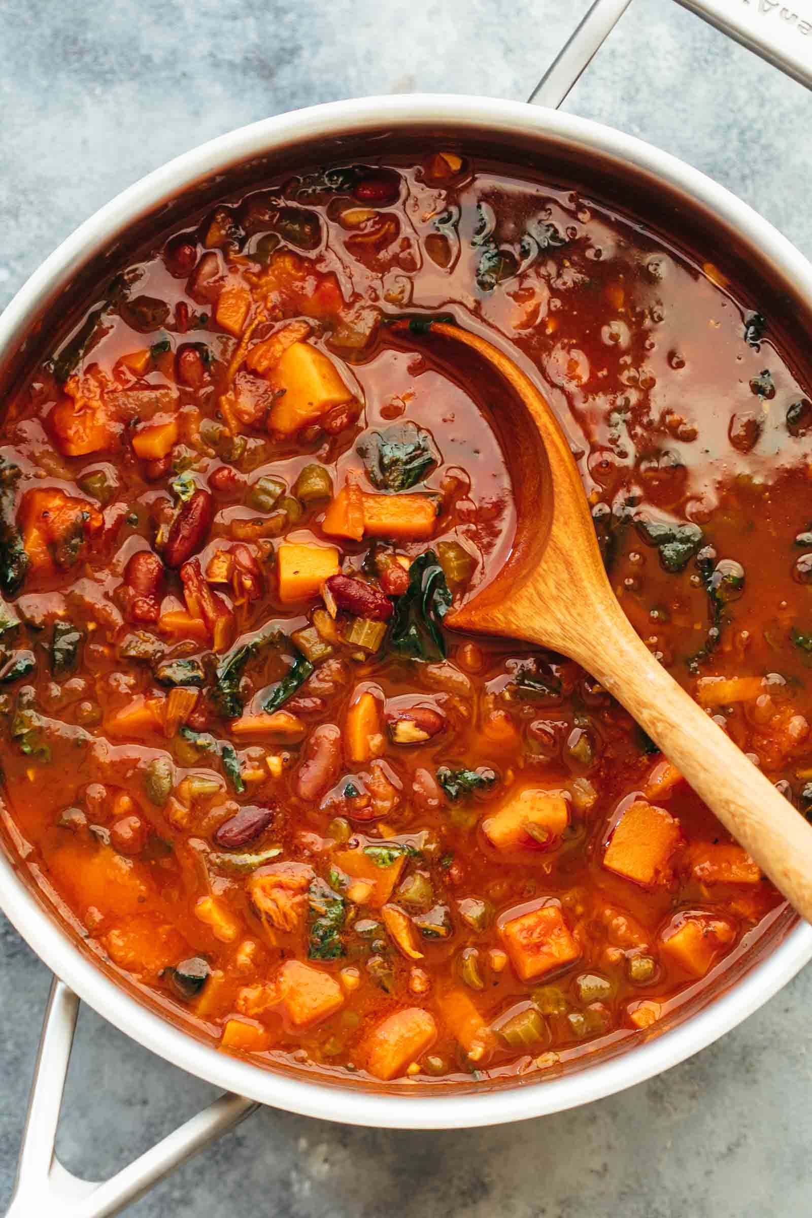 Winter Vegetarian Minestrone Soup straight from the stove in a pot with ladle