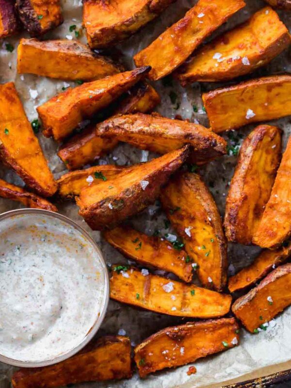 Chilli Lime Sweet Potato Wedges baked and served on a tray with a dipping sauce