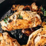 Spinach Mushroom stuffed Chicken Breast cooked in a cast iron pan.