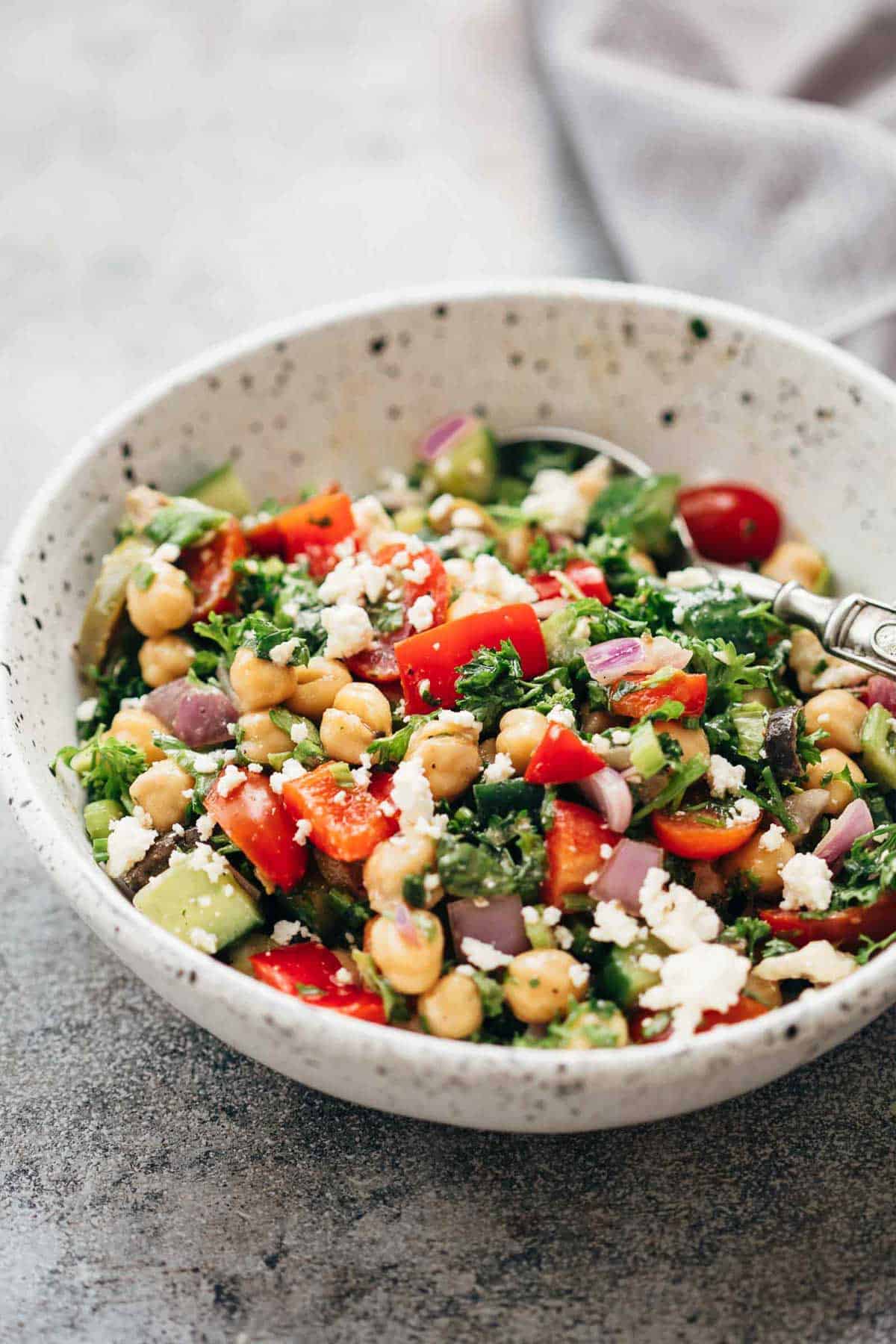 Easy Mediterranean chickpea salad served in a ceramic bowl with a spoon