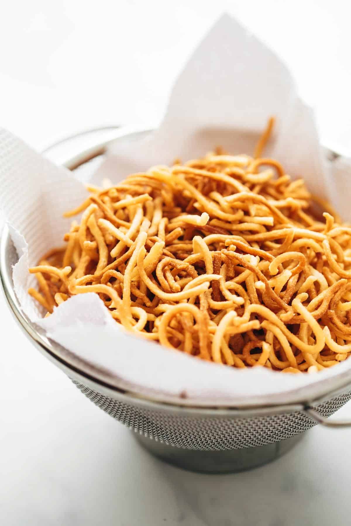 Crispy Fried Noodles stored on tissue paper in a sieve