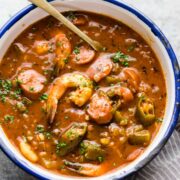 New Orleans Shrimp Sausage Gumbo served in an enamel bowl with a spoon