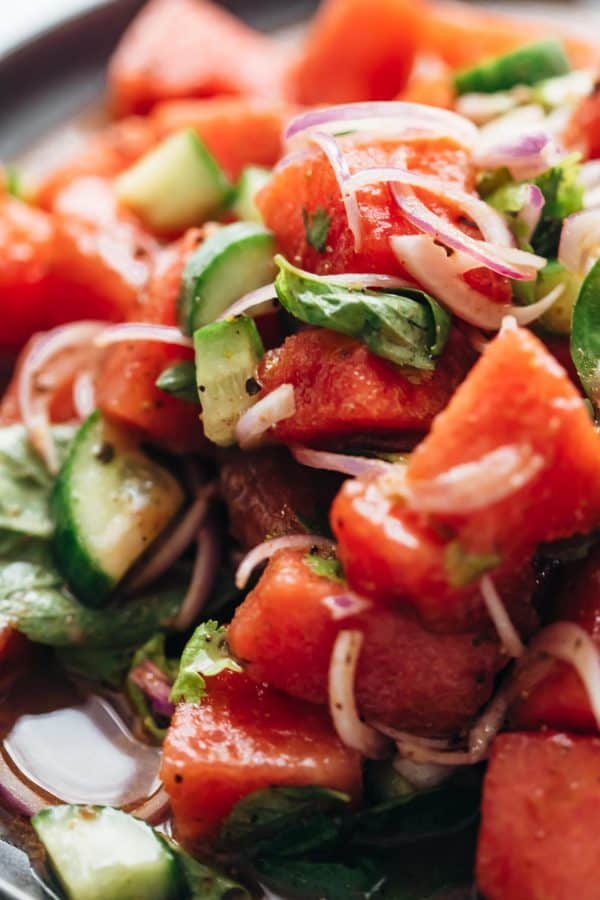 Closeup of watermelon salad with basil and cucumber