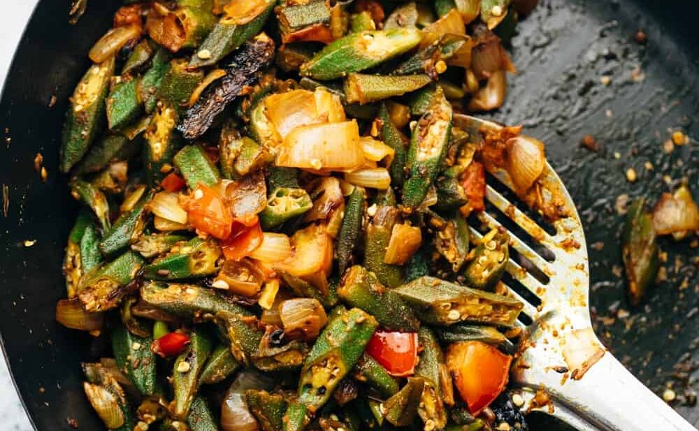 Overhead shot of bhindi masala fry in wok straight from the stove