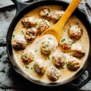 Creamy chicken meatballs in mushroom sauce in a pan