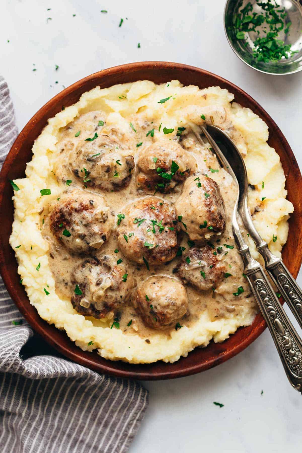 Creamy chicken meatballs in mushroom sauce served over mashed potatoes in a bowl