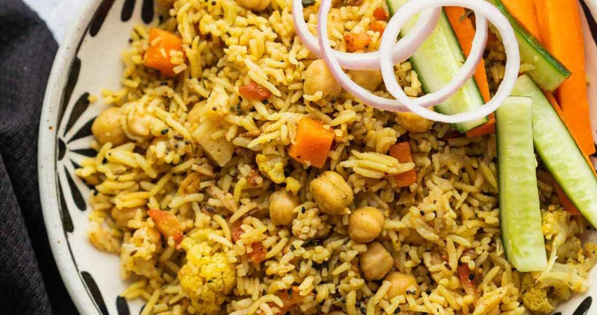 Kabuli Chana Pulao served in a bowl with onions and a salad