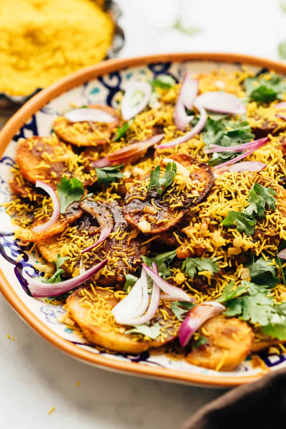 Closeup of easy aloo chaat - delhi style served on a plate with sev and lime on the side