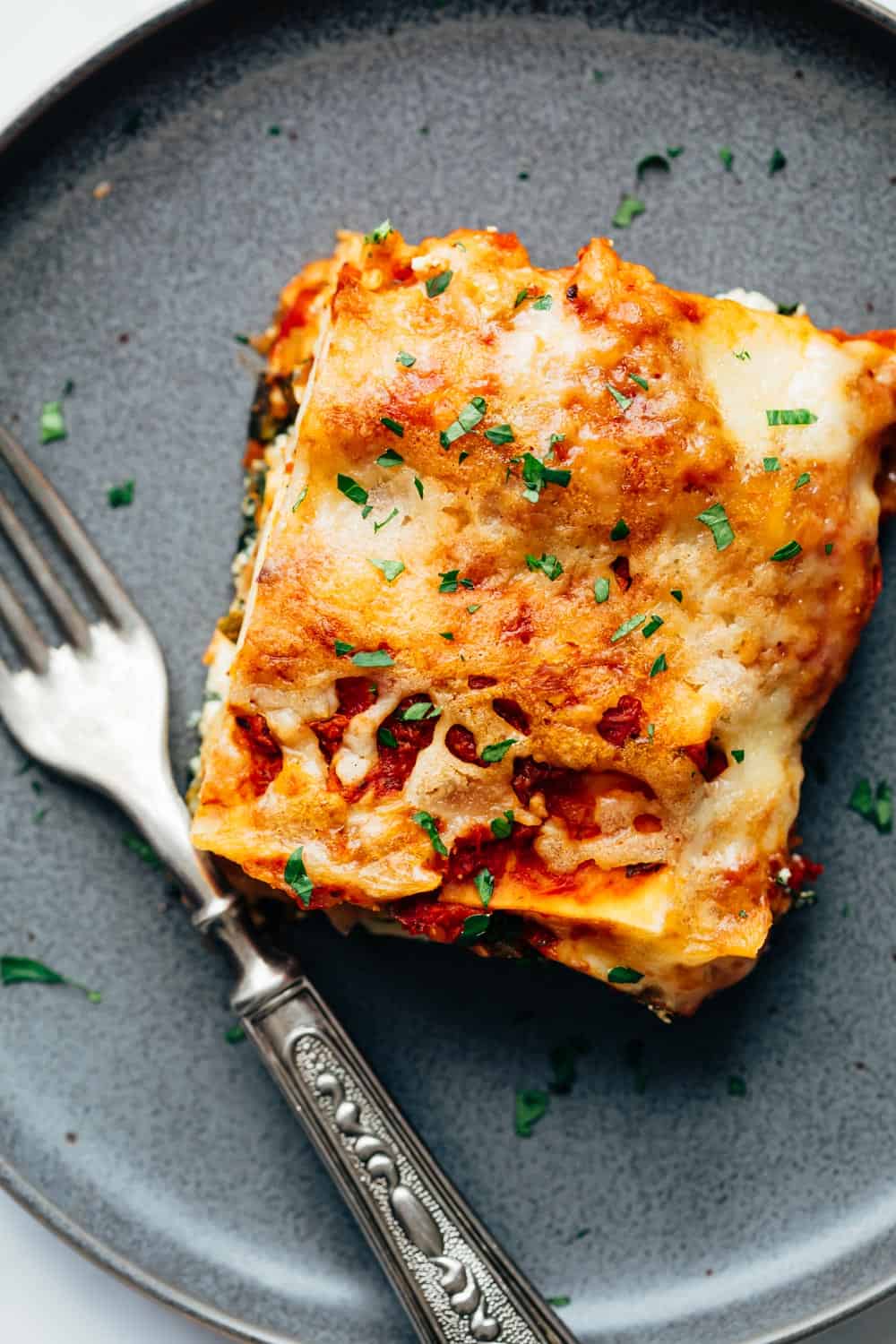 Slice of reheated frozen vegetarian lasagna on a plate