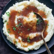 Brown vegetarian gravy poured on mashed potatoes