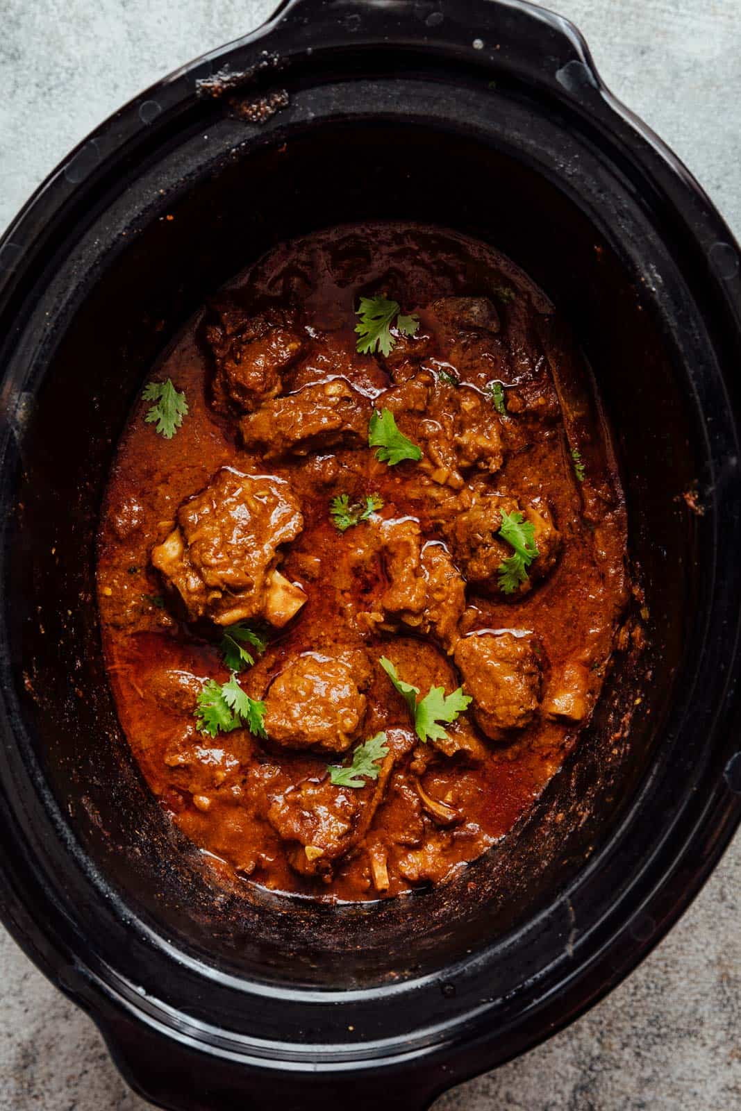 Slow cooker lamb curry pictured in a slow cooker