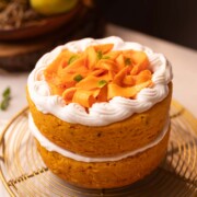 an image of a whole eggless mango cake placed on a wire rack