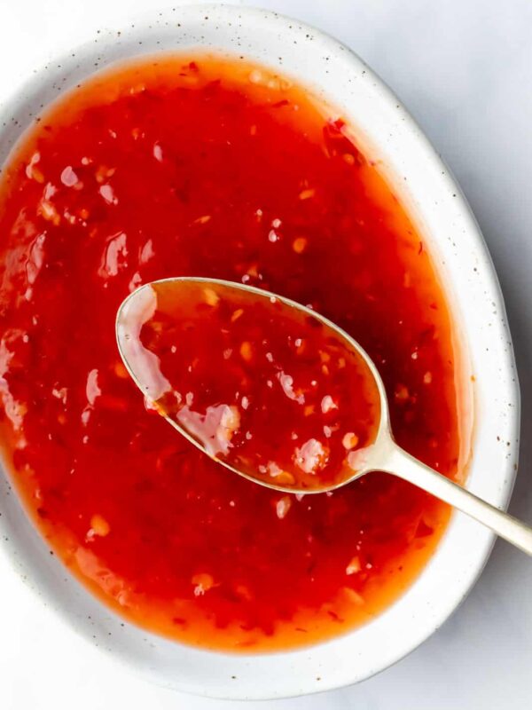Thai sweet chili sauce served in a bowl with a spoon in it