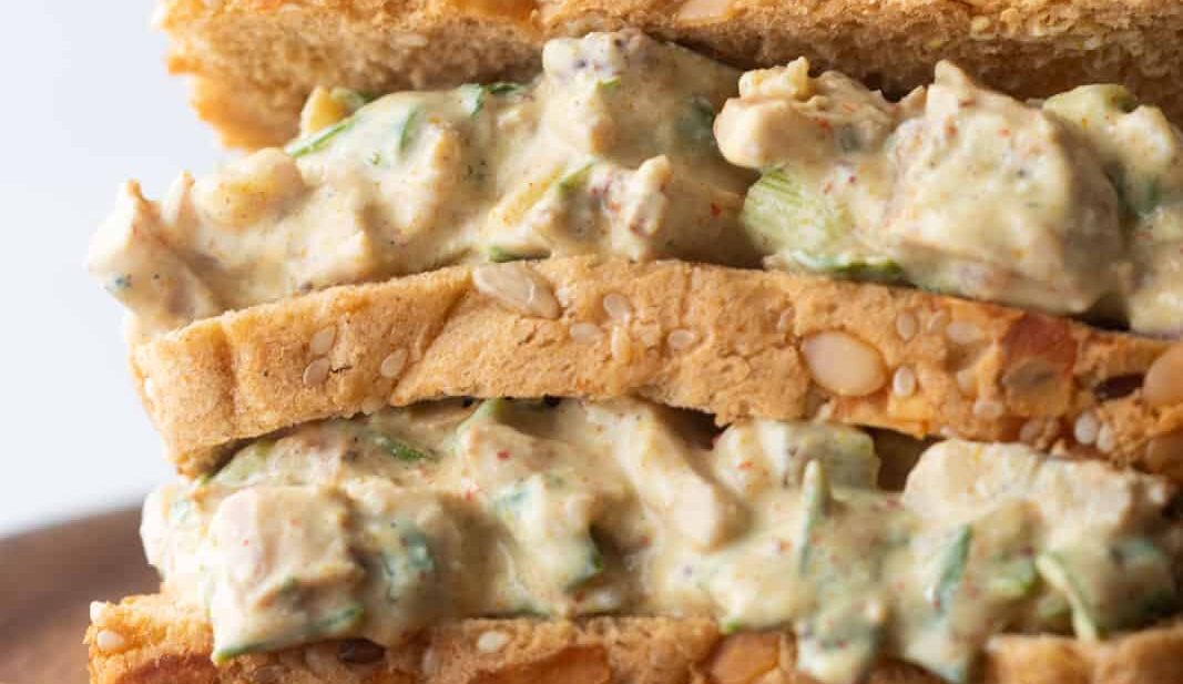 Closeup of curry chicken salad sandwich on a plate